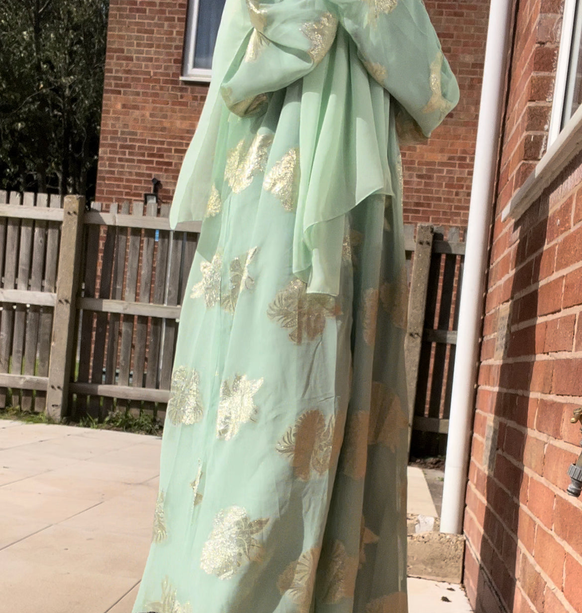 An open fransawi dress in sage gereen