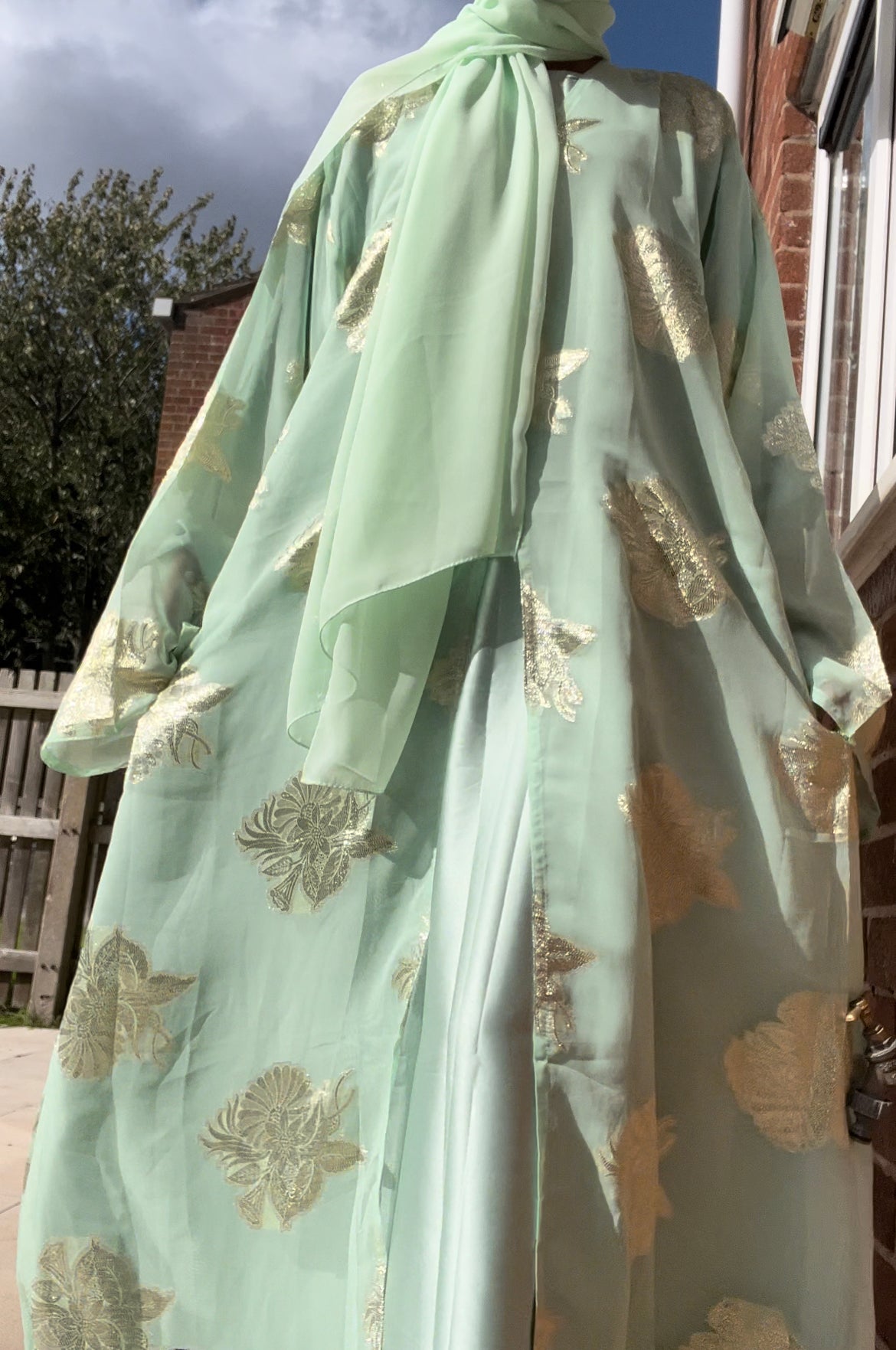 An open fransawi dress in sage gereen