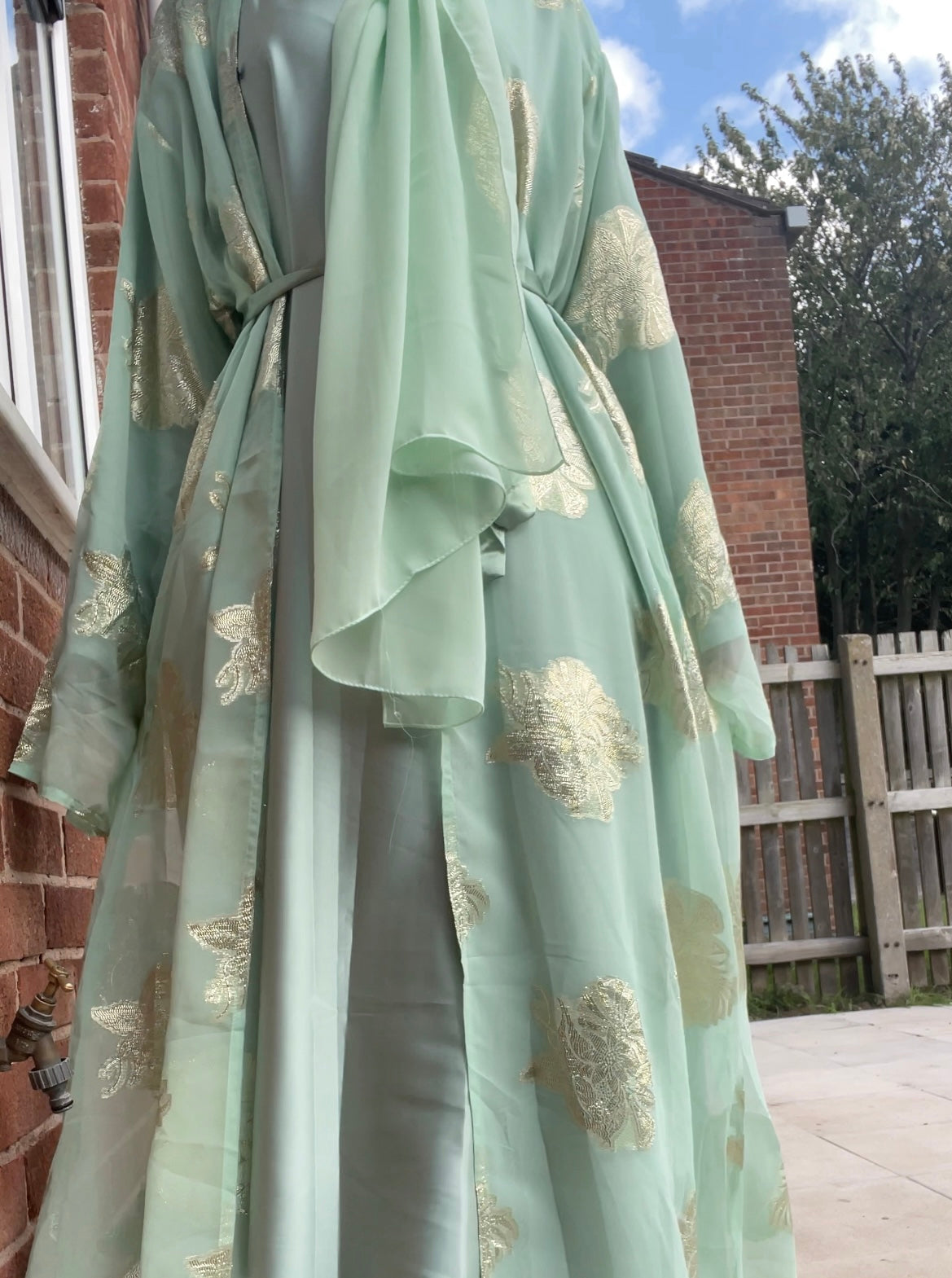 An open fransawi dress in sage gereen