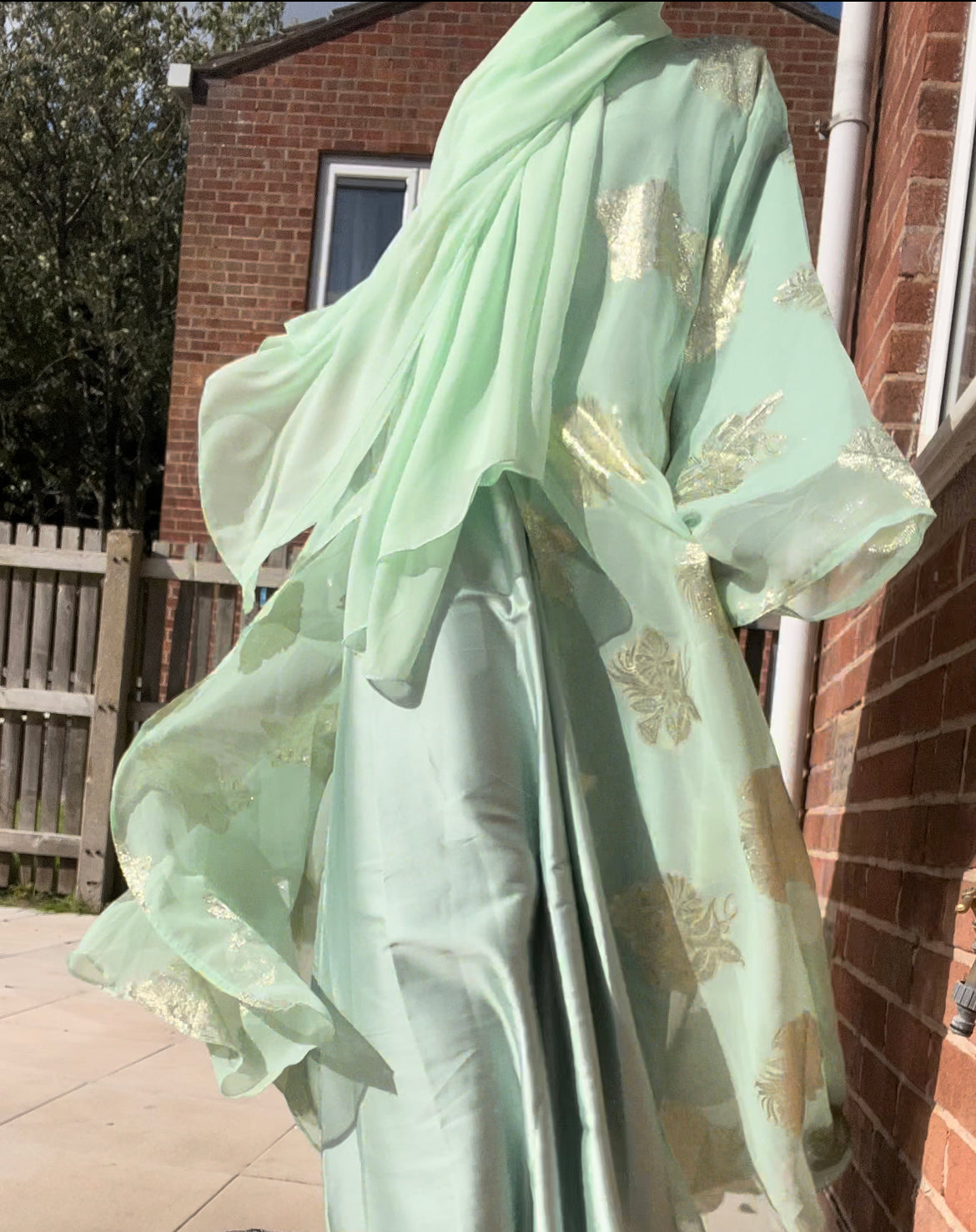 An open fransawi dress in sage gereen